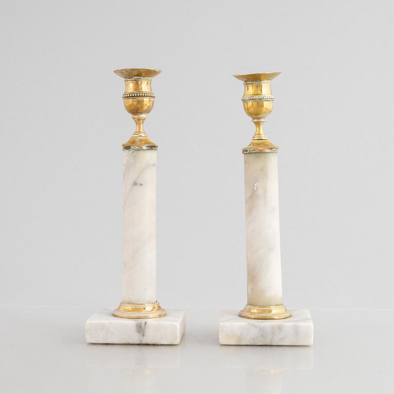A pair of Gustavian gilt brass and marble candlesticks, late 18th century.
