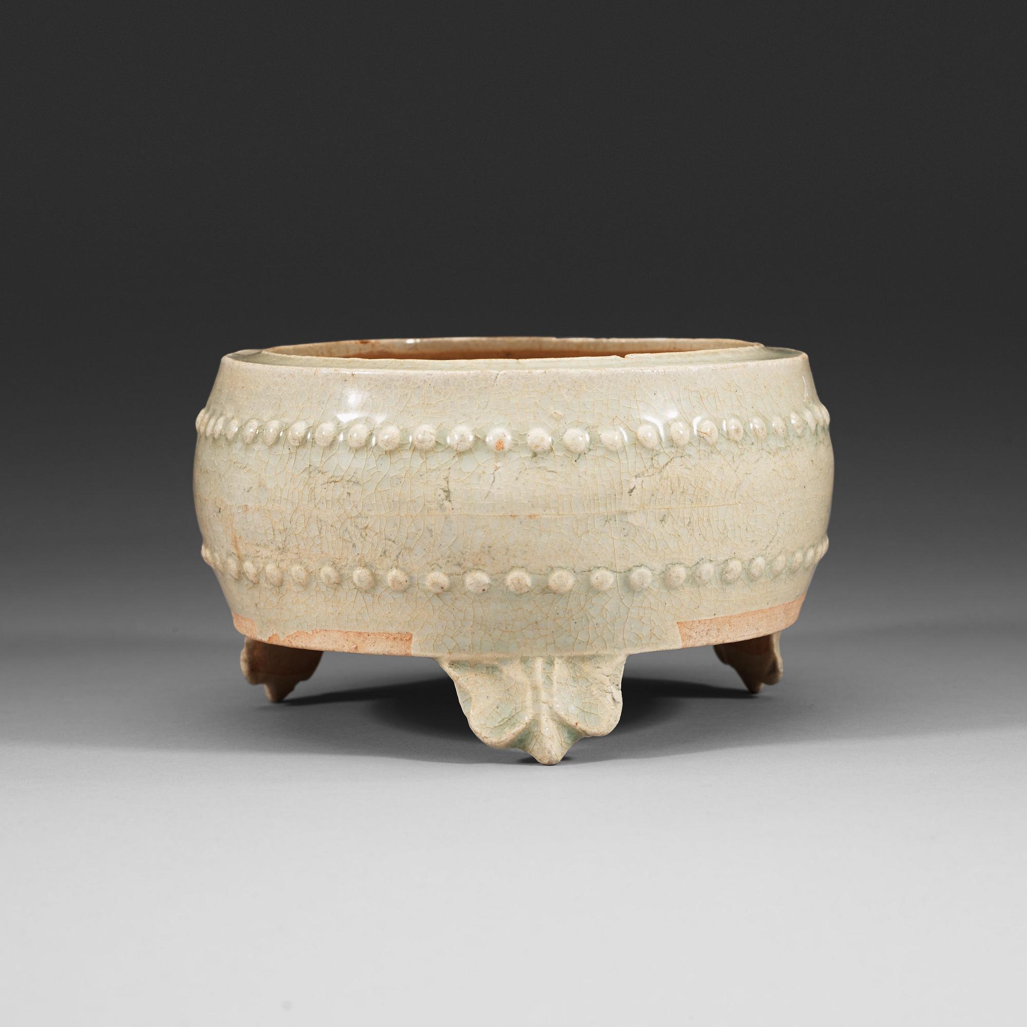 A pale celadon glazed tripod censer, presumably Yuan dynasty (1280-1367).