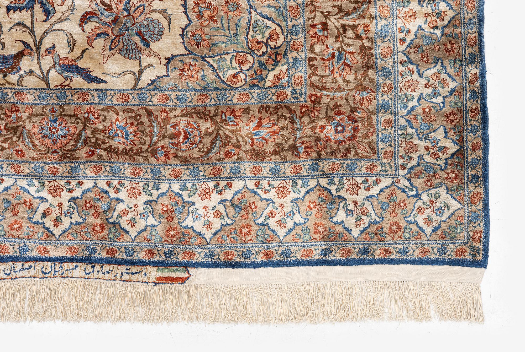 A semi-antique silk Isfahan rug, Central Persia, signed (Sadegh) Seirafian, c. 209 x 142 cm.