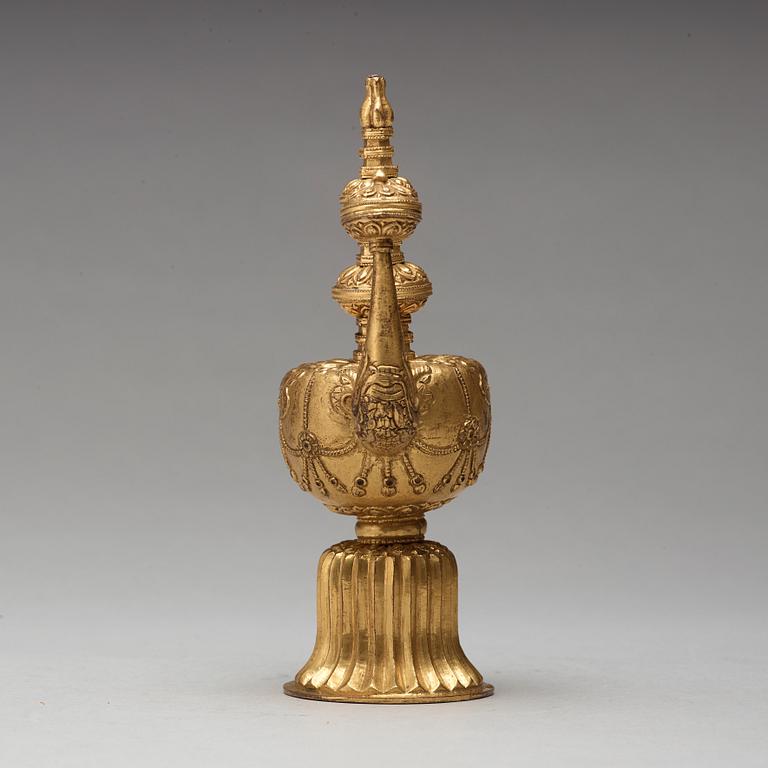 A Tibetan gilt copper bumpa, 19th Century.