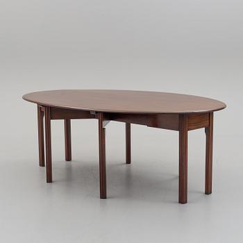 A DINING TABLE, England, made for NK, Nordiska Kompaniet, Sweden. Signed with label. Probably 1960s / 70s.