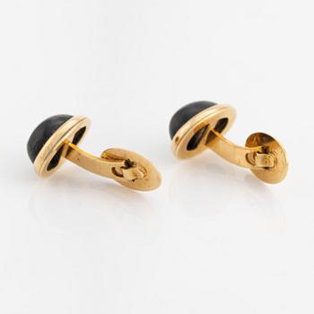 18K gold and cabochon cut blue stone cufflinks.