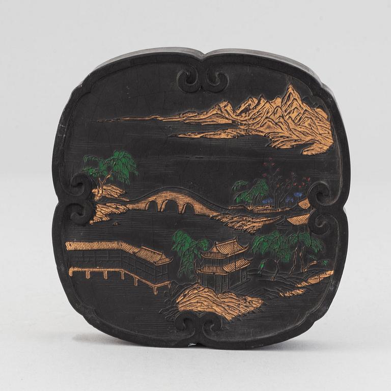 A Chinese ink-cake, with calligraphy and decorated with an ox, 20th Century.