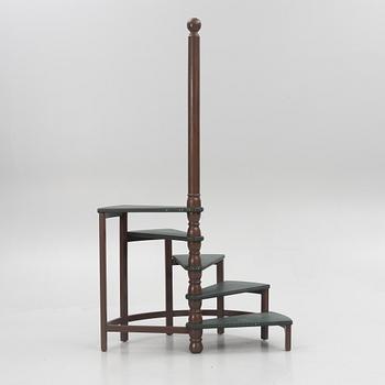 Amid 20th century library ladder.