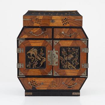 A Japenese partially lacquered hanging cabinet, early 20th century.