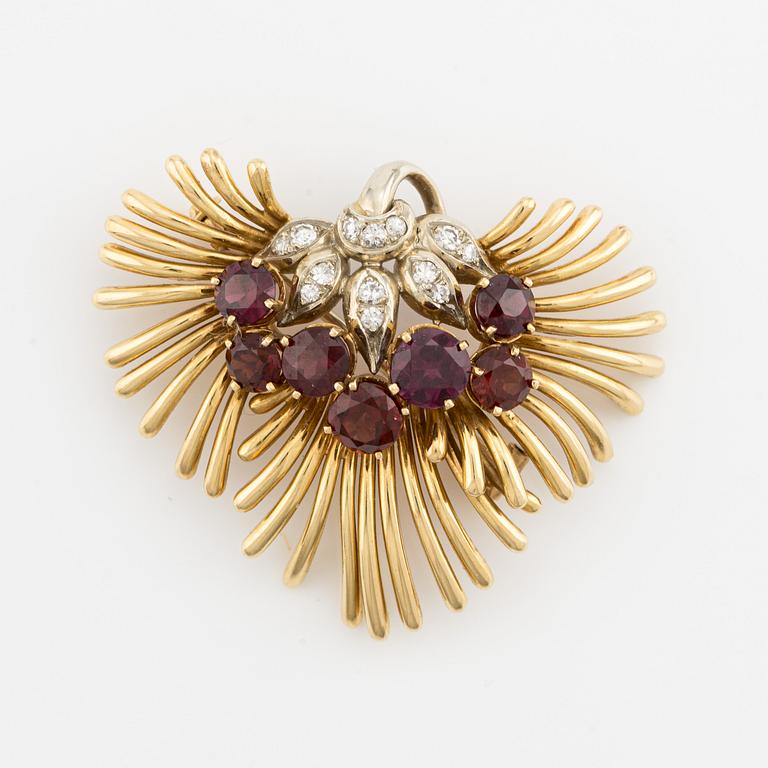 Brooch/pendant in 18K gold with rubies, garnets, and octagon-cut diamonds.