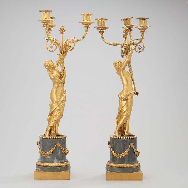 A pair of Louis XVI circa 1780 three-light gilt bronze and bleu turquin marble candelabra.