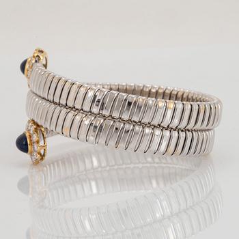 An 18K gold bangle set with cabochon-cut sapphires and round brilliant-cut diamonds.