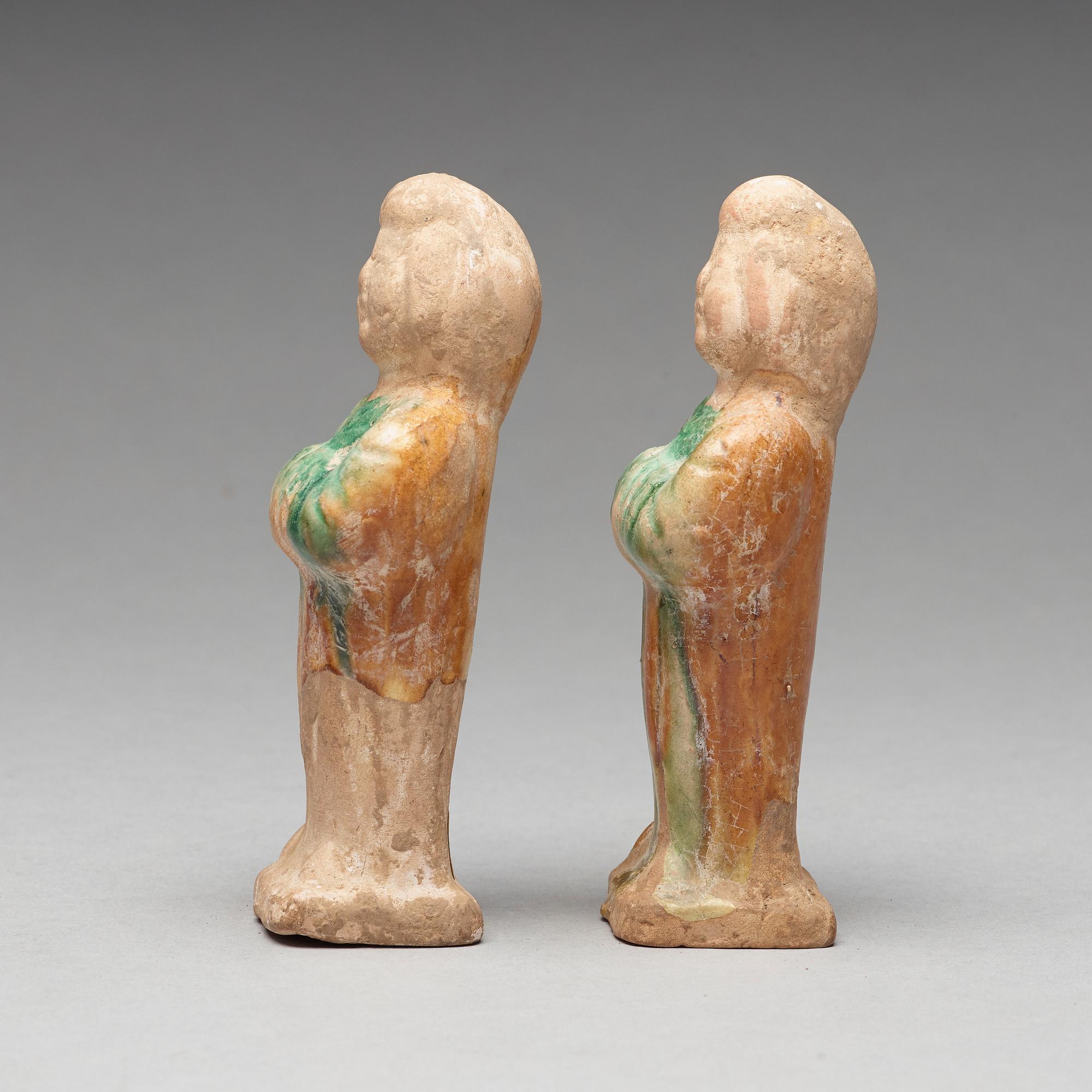 Two green and yellow glazed pottery figures of female attendants, Ming dynasty (1368-1644).