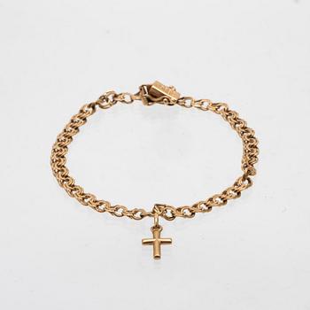 An 18K gold bracelet with a charm.