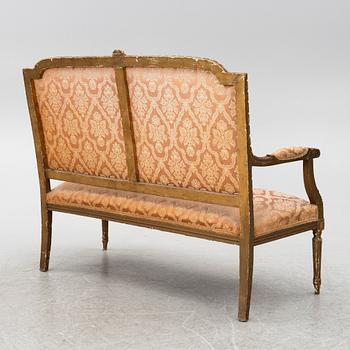 A pair of Louis XVI-style armchairs and a sofa, 20th century.