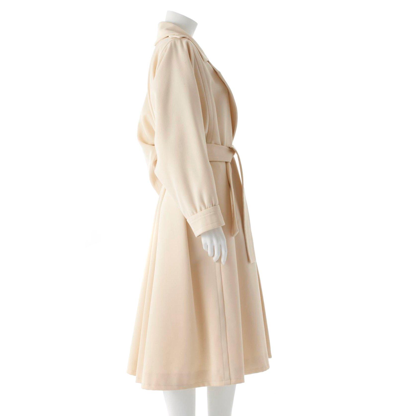 YVES SAINT LAURENT, a creme colored wool blend coat.