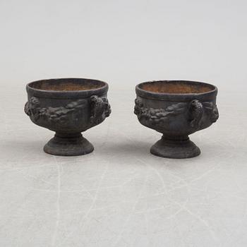 A pair of early 20th century iron garden urns.