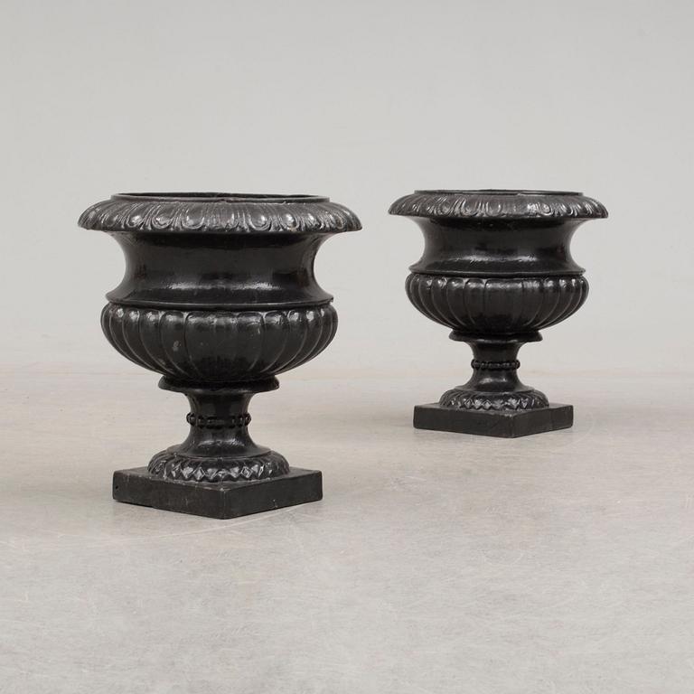 A pair of cast iron plant pots. Late 20th century.