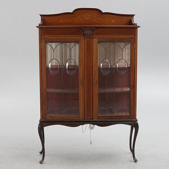 A display cabinet, England, early 20th century.