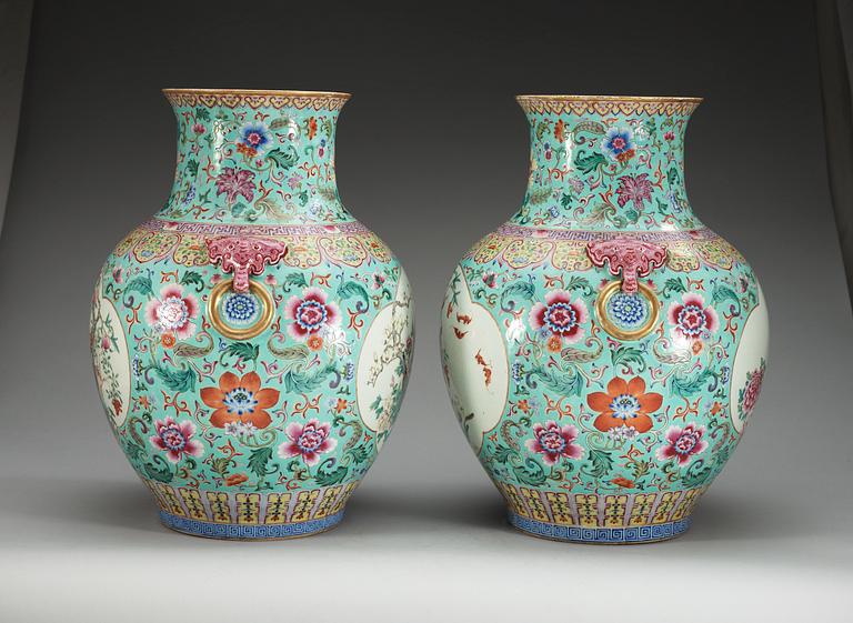 A large pair of turquoise ground famille rose vases, early 20th Century with Qianlongs sealmark.