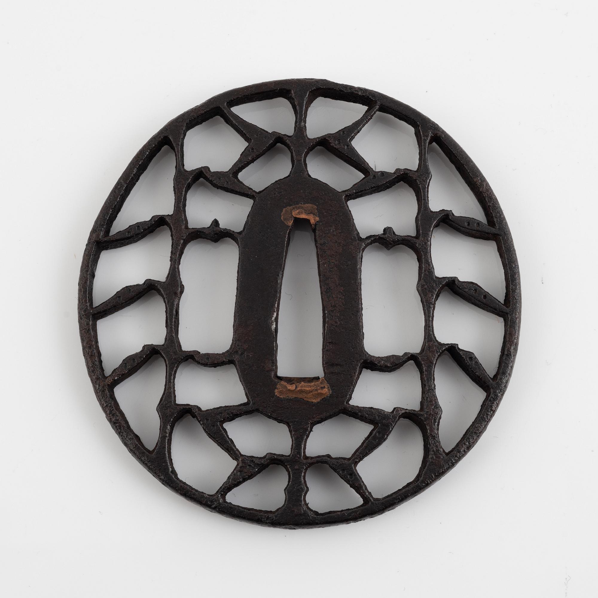 An iron open work, sukashi, Japanese tsuba, Edo (1603-1868). In a kiri box.
