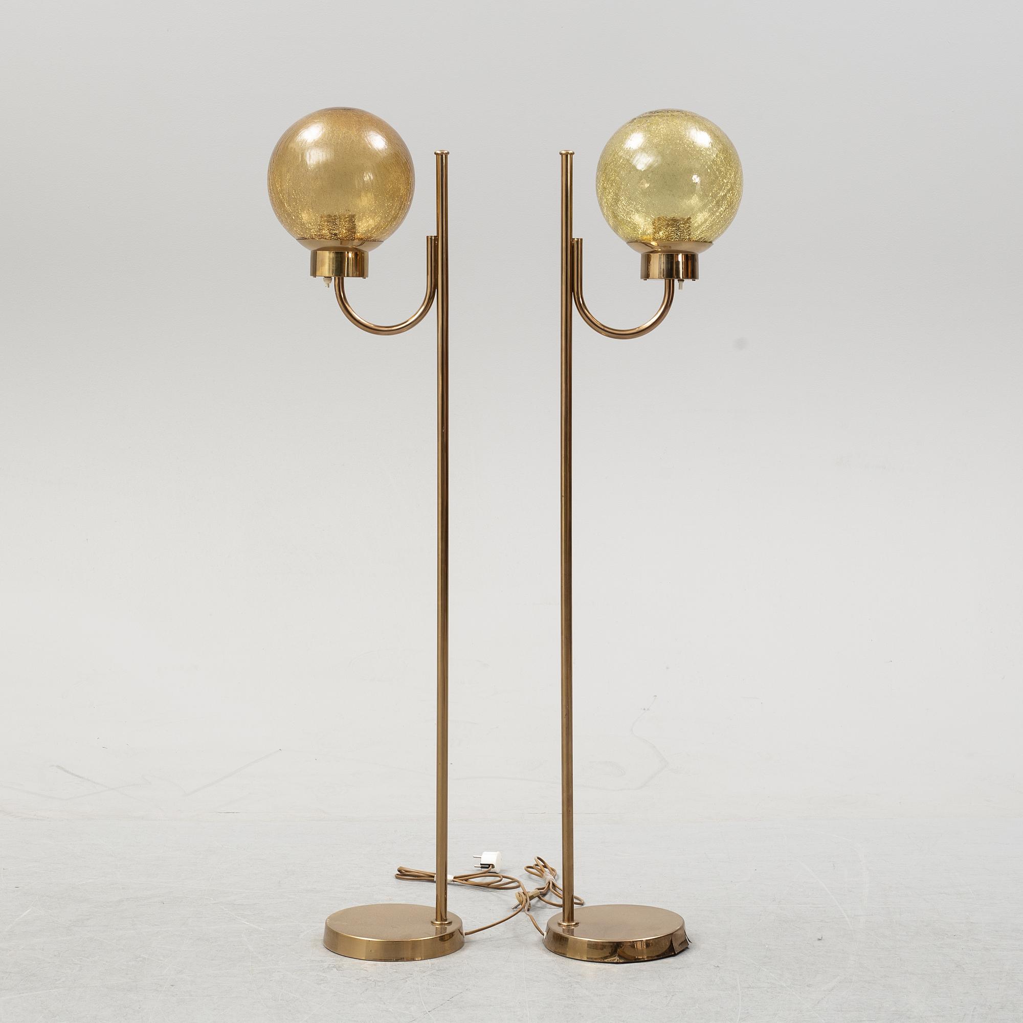 Bergboms, a pair of model 'G-118', brass and glass floor lamps. Second half of the 20th century.