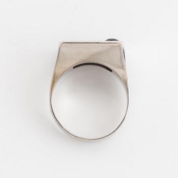 An 18K white gold ring set with round brilliant-cut diamonds and colored stones.