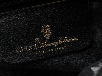 A blue monogram canvas bag by Gucci.