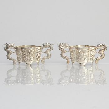 A pair of  Chinese silver cup holders/salts, 20th century.