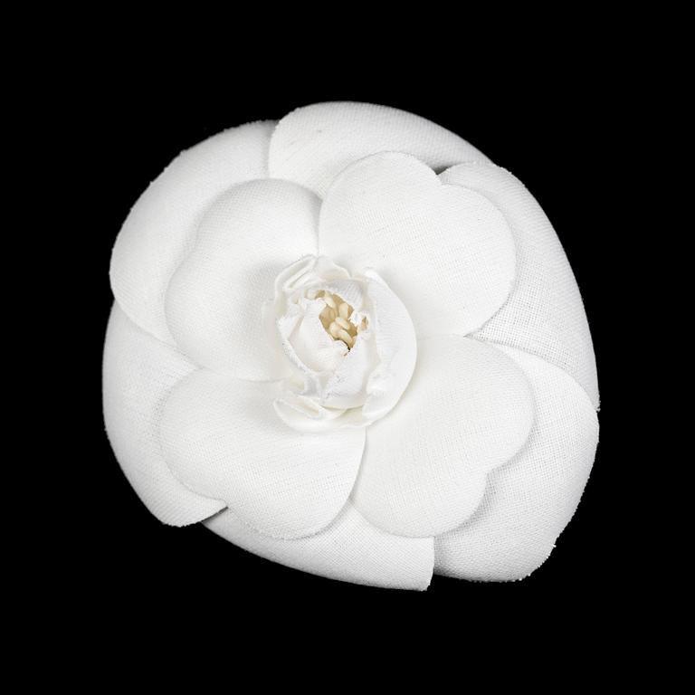 A white camelia brooch by Chanel.