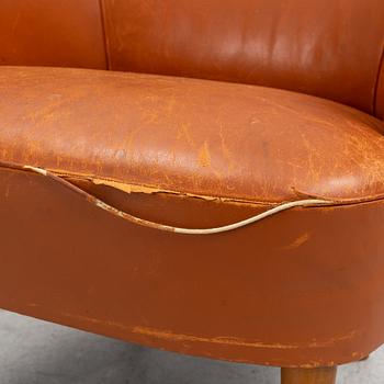 Carl Malmsten, A leather upholstered armchair, model "Lillasyster", O.H. Sjögren, second half of the 20th century.