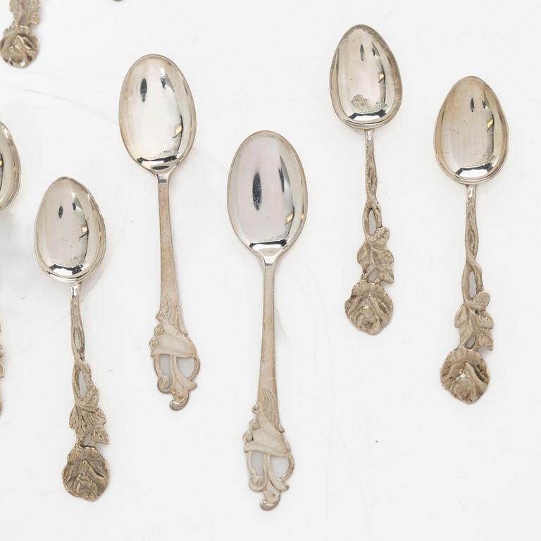 A pair of beakers, two napkin rings, and 17 pieces of cutlery, silver.