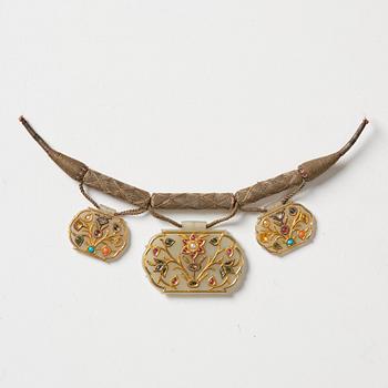 1046. Three gold-inlaid and gem-set jade pendants, India, 19th century.