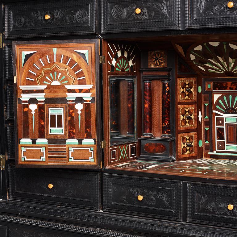 A Louis XIV and Louis XIV-style carved ebony, ivory and tortoiseshell-inlaid cabinet on stand, 17th and 19th century.