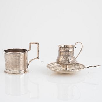 A silver teacup and saucer, possibly Pavel Perepyekin, Moscow 1885 and silver tea glass holder, 1891.