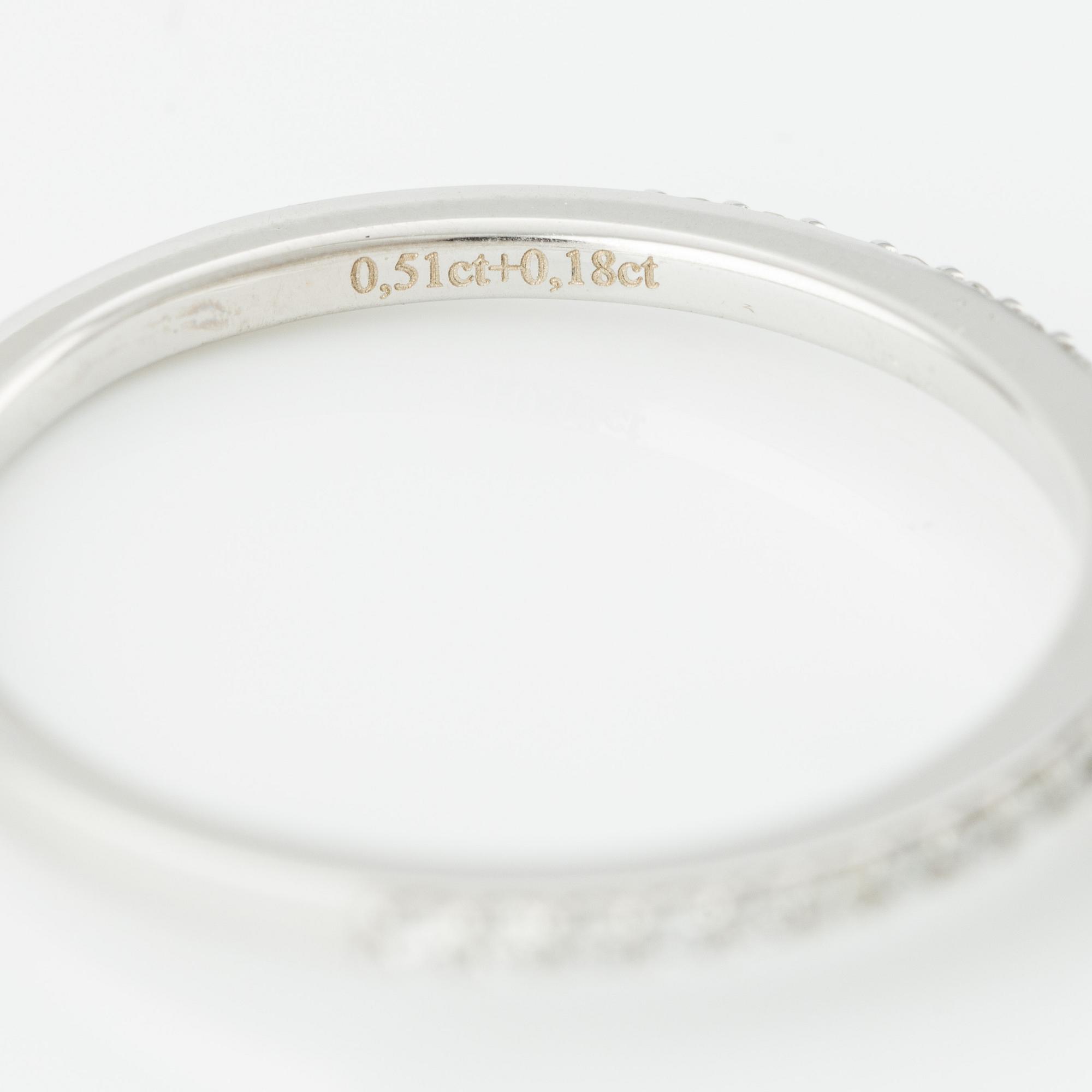 Ring with cushion-cut diamond.