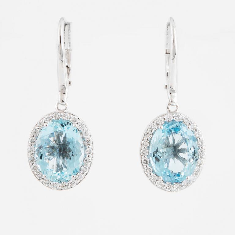 A pair of 18K gold earrings set with faceted aquamarines.