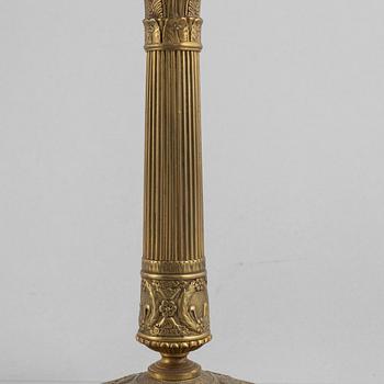 A pair of Empire gilt brass candle sticks, first half of the 20th century.