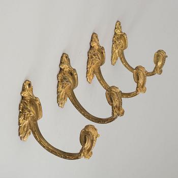 Four 19th century bronze tie-backs.