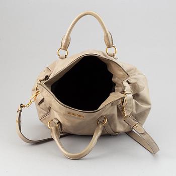 Miu Miu, a leather handbag.