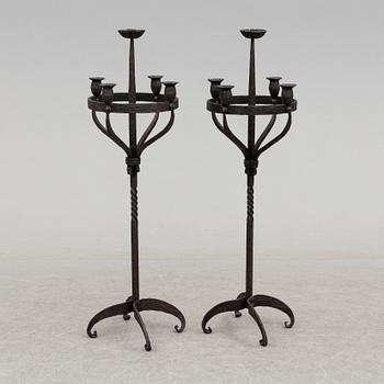 a pair of iron floor candle sticks, 20th century.