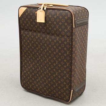 A Monogram Canvas Pégase 65 Suitcase with a Protective Cover.