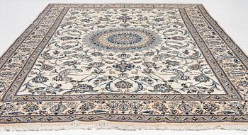 An Oriental carpet, approx. 354 x 243 cm.