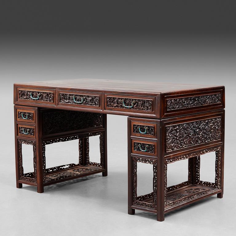 A carved hardwood desk, late Qing dynasty, circa 1900.