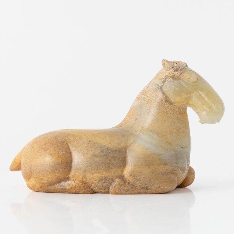 A carved nephrite figure of a reclining horse, 20th Century.