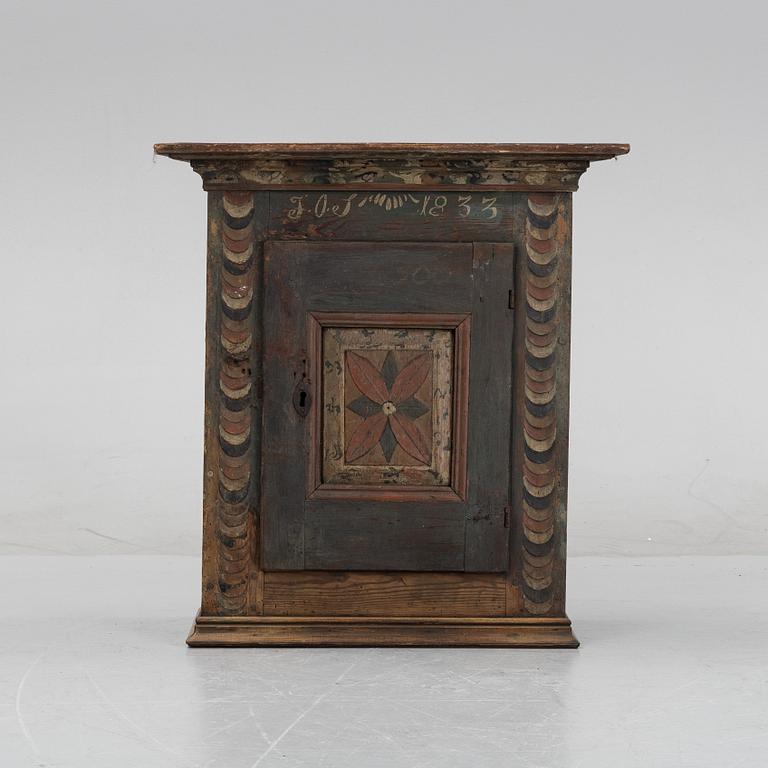 A Swedish provincial wall hanging cabinet, 1833.