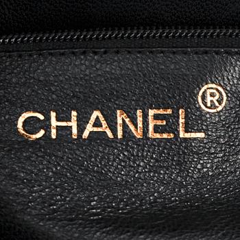 CHANEL, a black patent leather shoulder back.