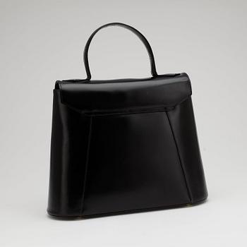 YVES SAINT LAURENT, a black leather top handle bag.