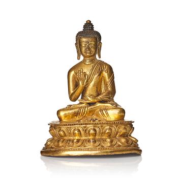 999. A gilt bronze figure of buddha, Tibet, presumably 18/19th Century.