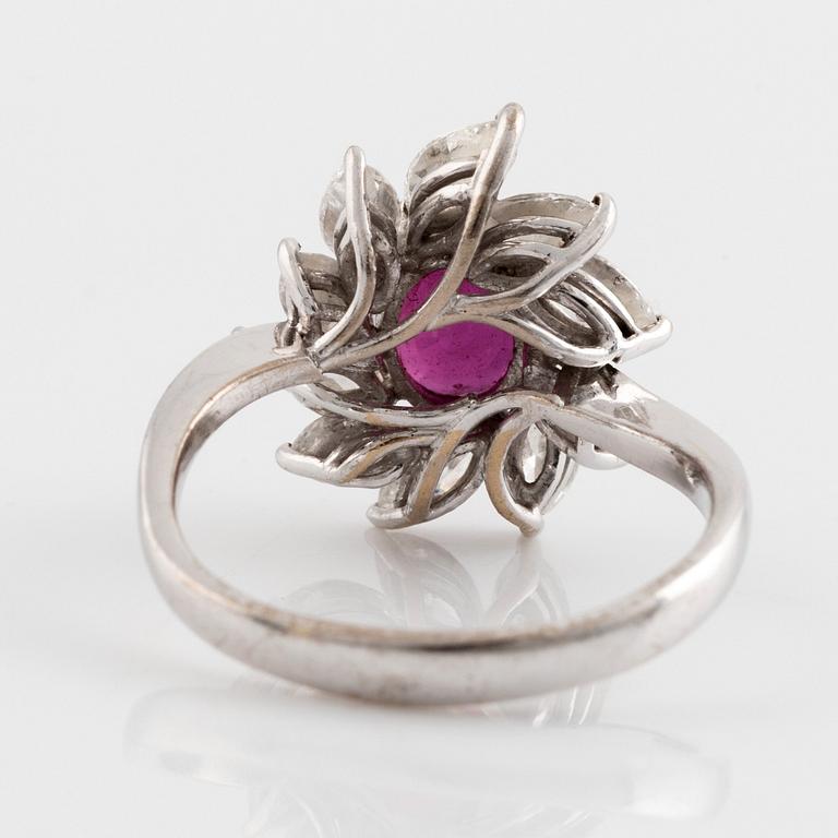 A ring set with a faceted ruby and navette-cut diamonds.