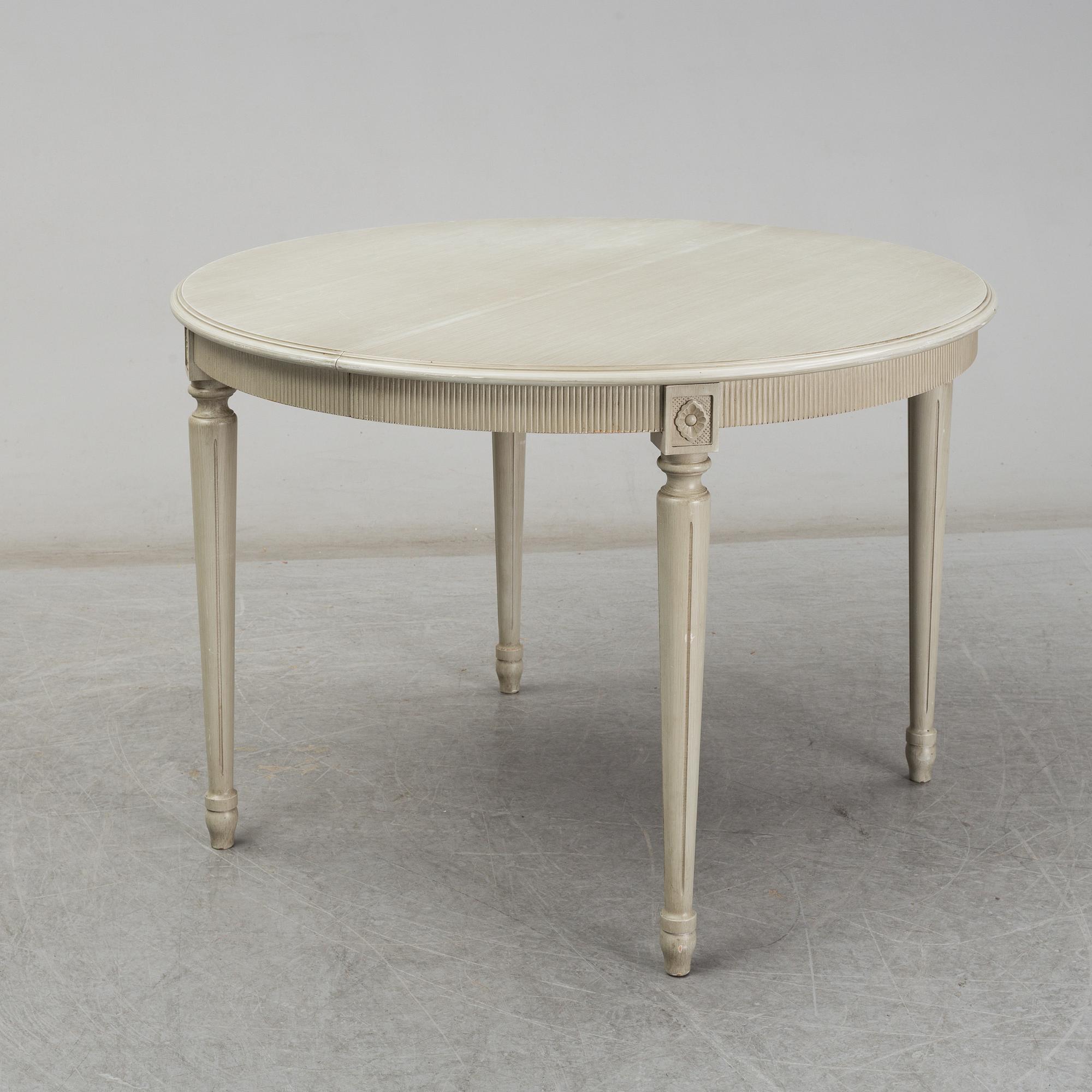 A dining table and six chairs, Gustavian style, second half of the 20th century. One leaf included.