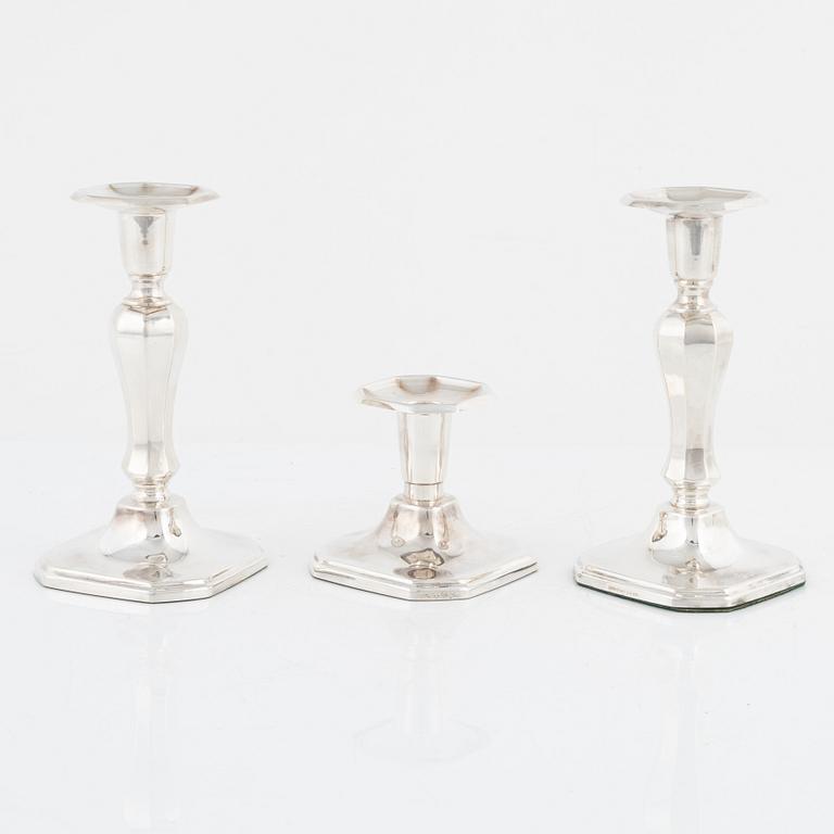 A pair of silver candlesticks, MGAB, Uppsala, 1985 and a silver candlestick, MEMA, Lidköping, 1987.