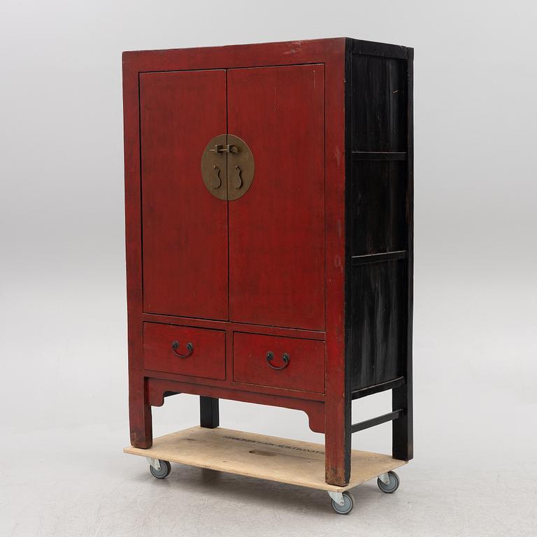 A red-lacquered cabinet, China, 20th century.