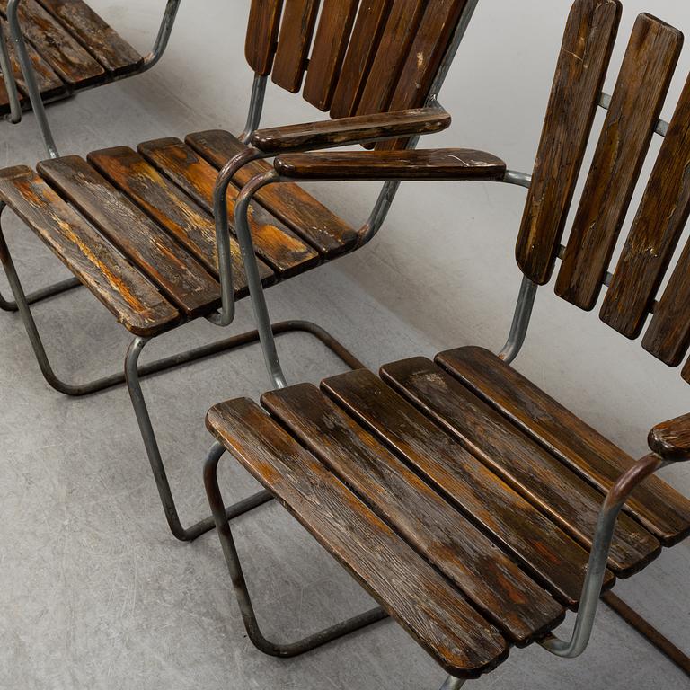 Four tubular steel and pine garden chairs, mid 20th Century.